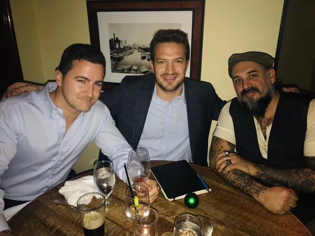 Bruce Elia Jr. sharing a celebratory dinner with two clients