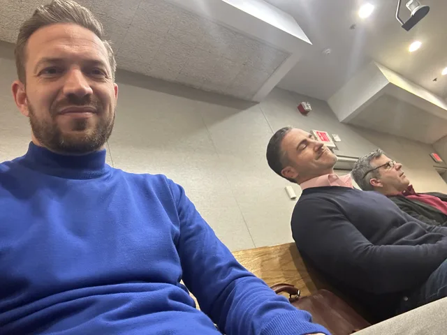 Bruce Elia Jr. taking a selfie with two clients seated beside him